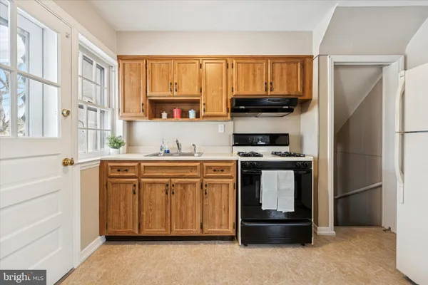 a kitchen with granite countertop a refrigerator stove and microwave
