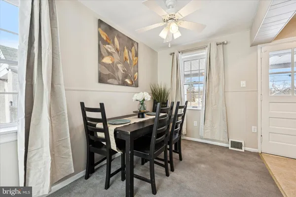 a view of a dining room with furniture and chandelier