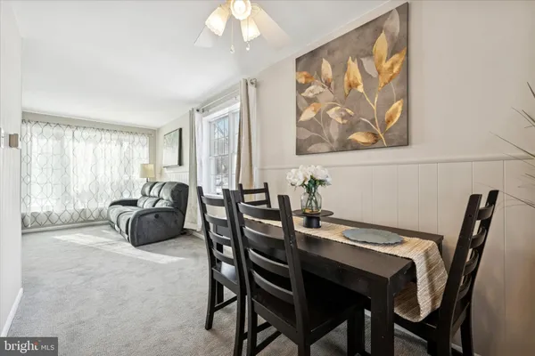 a dining room with furniture and window