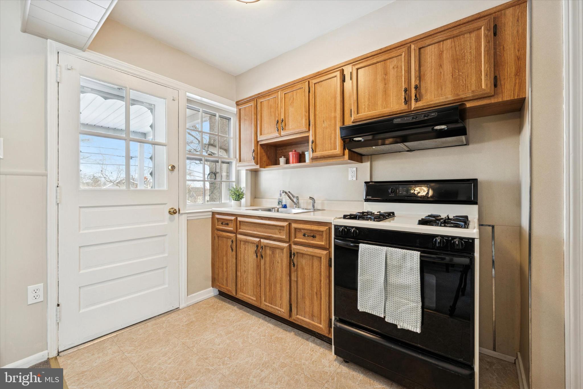 8711 Old Line Road Philadelphia, PA 19128 - Photo 8 of 21 a kitchen with stainless steel appliances granite countertop a stove microwave and cabinets