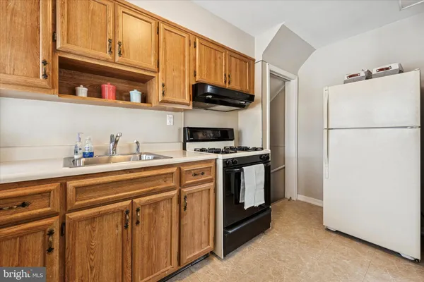 a kitchen with stainless steel appliances granite countertop a refrigerator sink and cabinets