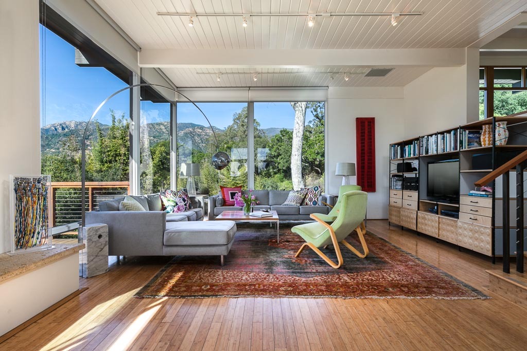 524 Barker Pass Road Montecito, CA 93108 - Photo 4 of 19 a living room with furniture a flat screen tv and a floor to ceiling window