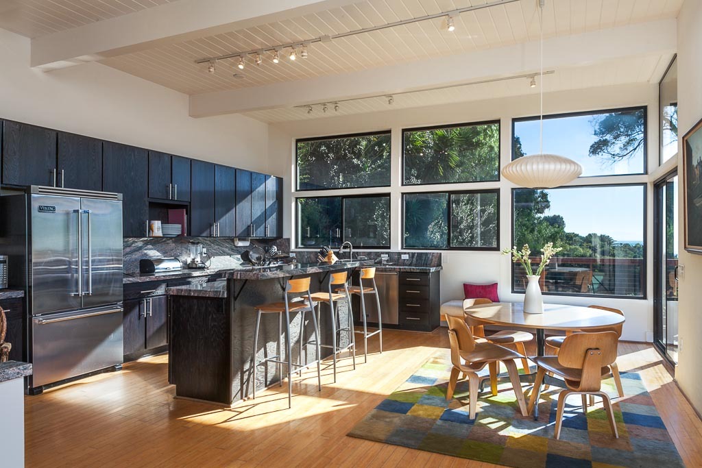 524 Barker Pass Road Montecito, CA 93108 - Photo 6 of 19 a kitchen with stainless steel appliances wooden floor dining table and chairs