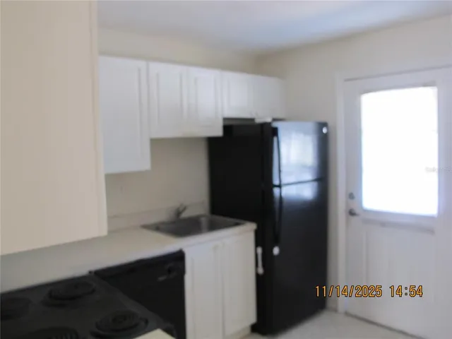 a kitchen with a refrigerator and cabinets