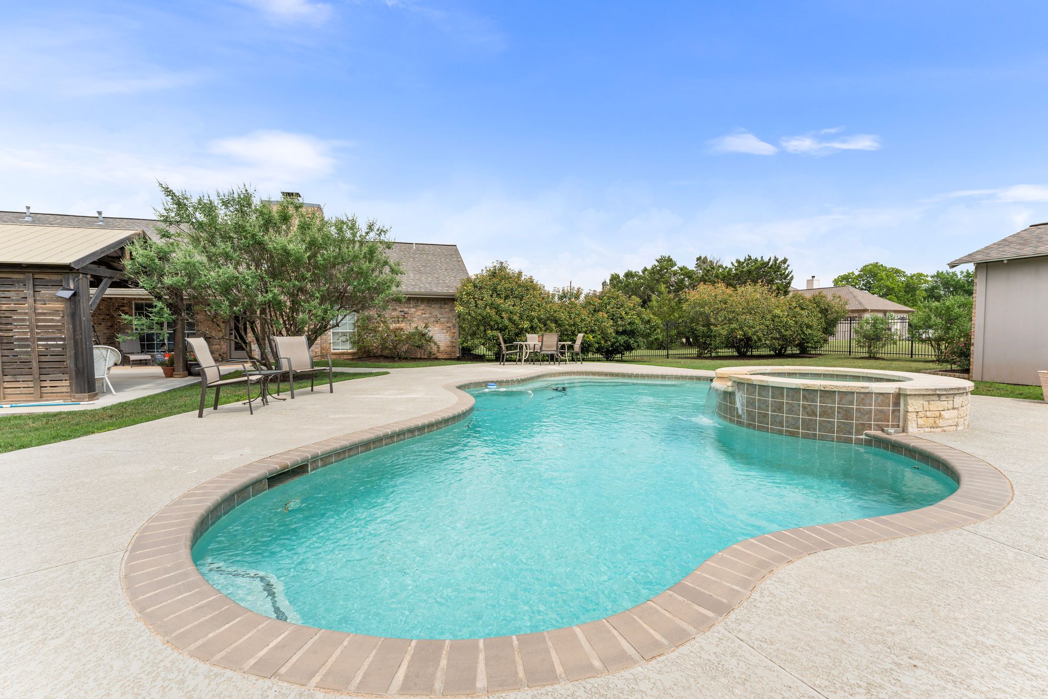221 Breakaway Road Cedar Park, TX 78613 - Photo 15 of 39 View of swimming pool with a patio area, a pool with connected hot tub, and fence