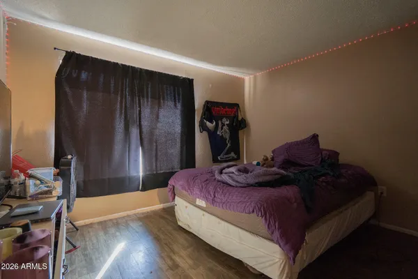 a bed sitting in a bedroom next to a small yard