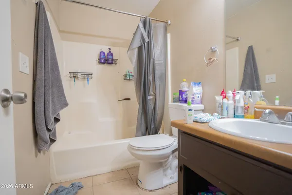 a bathroom with a sink a toilet and a shower