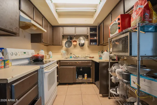 a kitchen with stainless steel appliances granite countertop a sink and cabinets