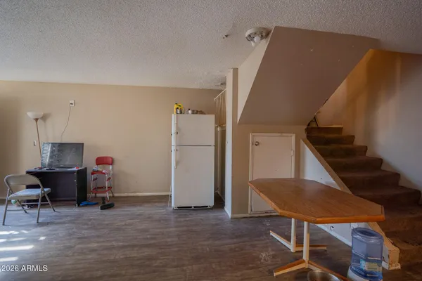 a view of a livingroom with furniture and staircase