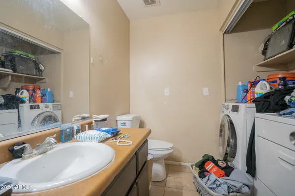 a bathroom with a sink mirror vanity and toilet