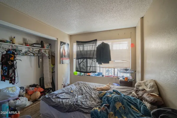 a bedroom with a bed and a mirror