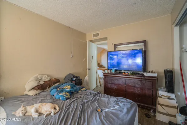 a bedroom with a bed and a flat screen tv