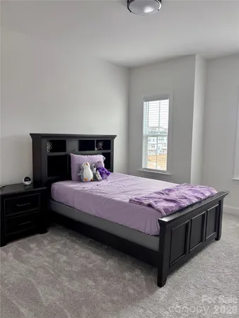 a bedroom with a bed and window