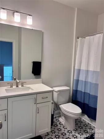 a bathroom with a toilet a sink and a shower