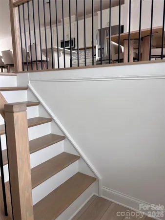 a view of staircase with white walls and a window