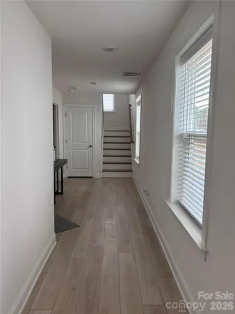 a view of a room with wooden floor and window