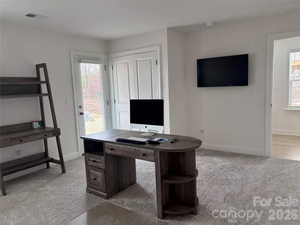 a view of a workspace with furniture