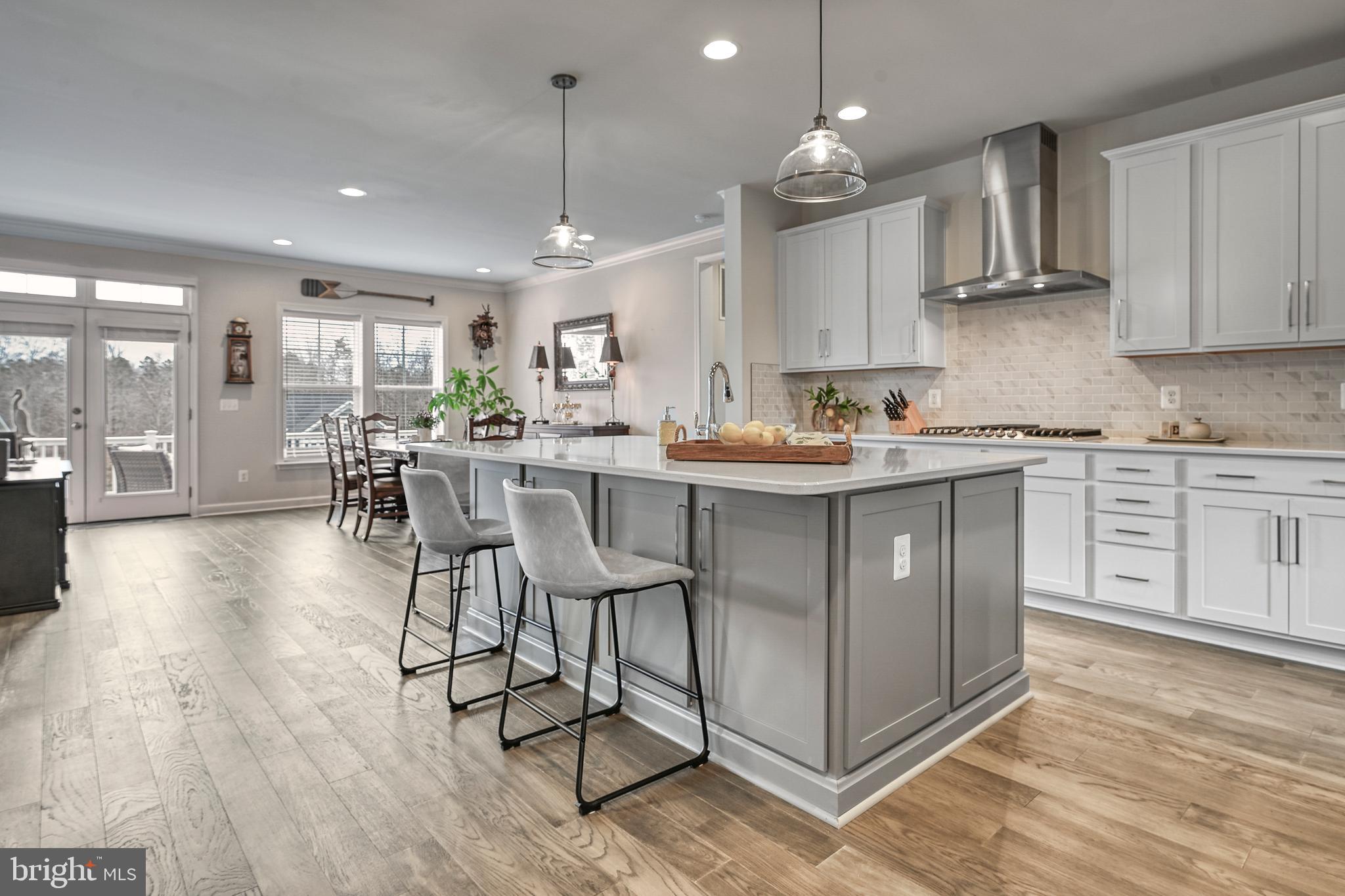 287 Sunset Loop Mineral, VA 23117 - Photo 23 of 112 a kitchen with stainless steel appliances granite countertop a stove top oven a sink dishwasher a dining table and chairs with wooden floor