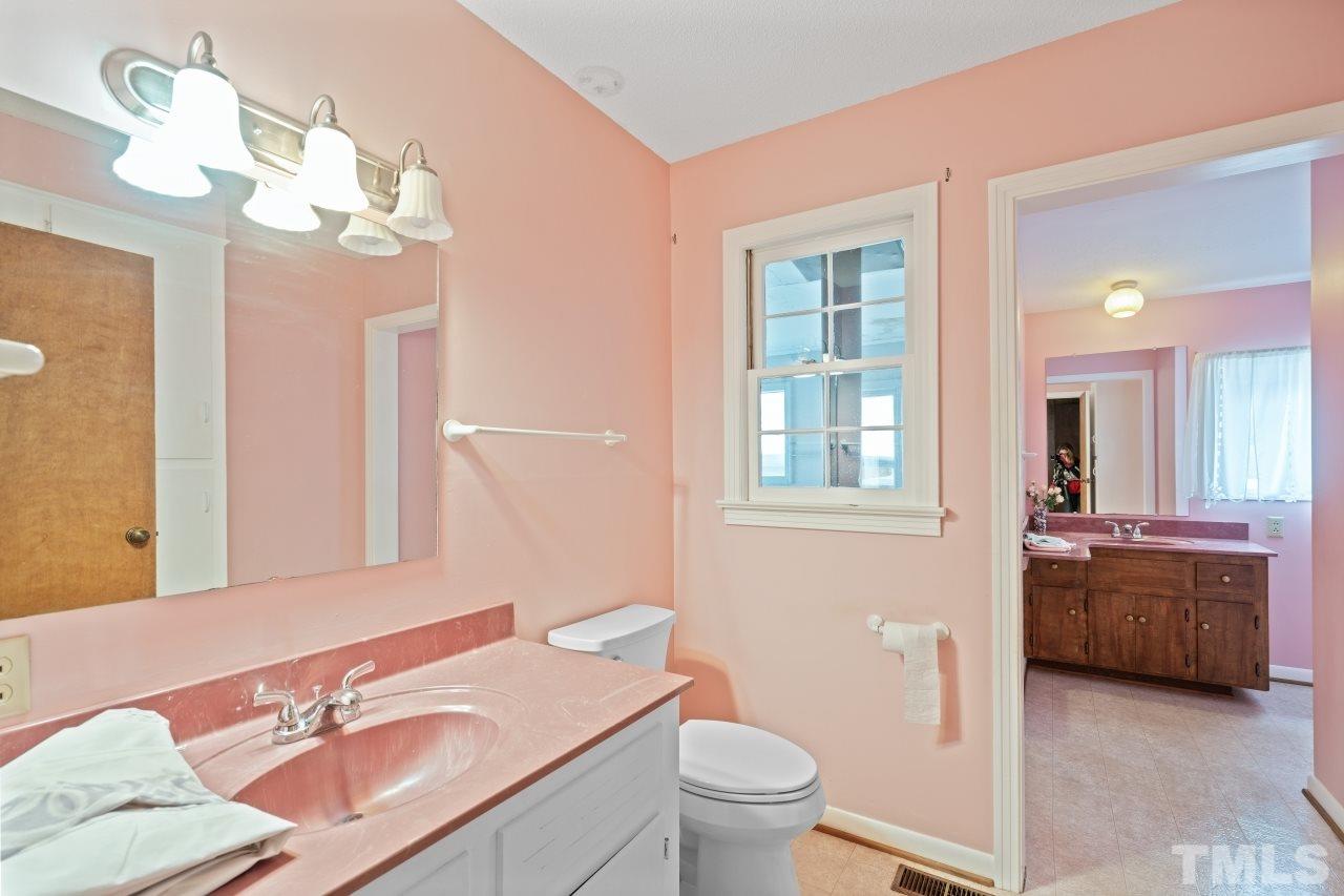 4762 Farrell Road Sanford, NC 27330 - Photo 11 of 18 a bathroom with a granite countertop sink a toilet and a mirror