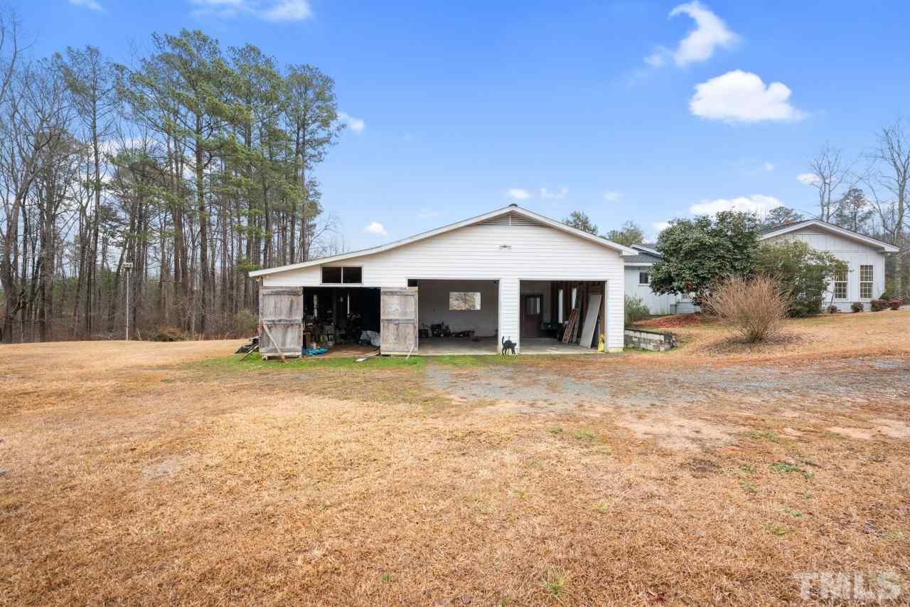 4762 Farrell Road Sanford, NC 27330 - Photo 3 of 18 a front view of a house with a yard and garage