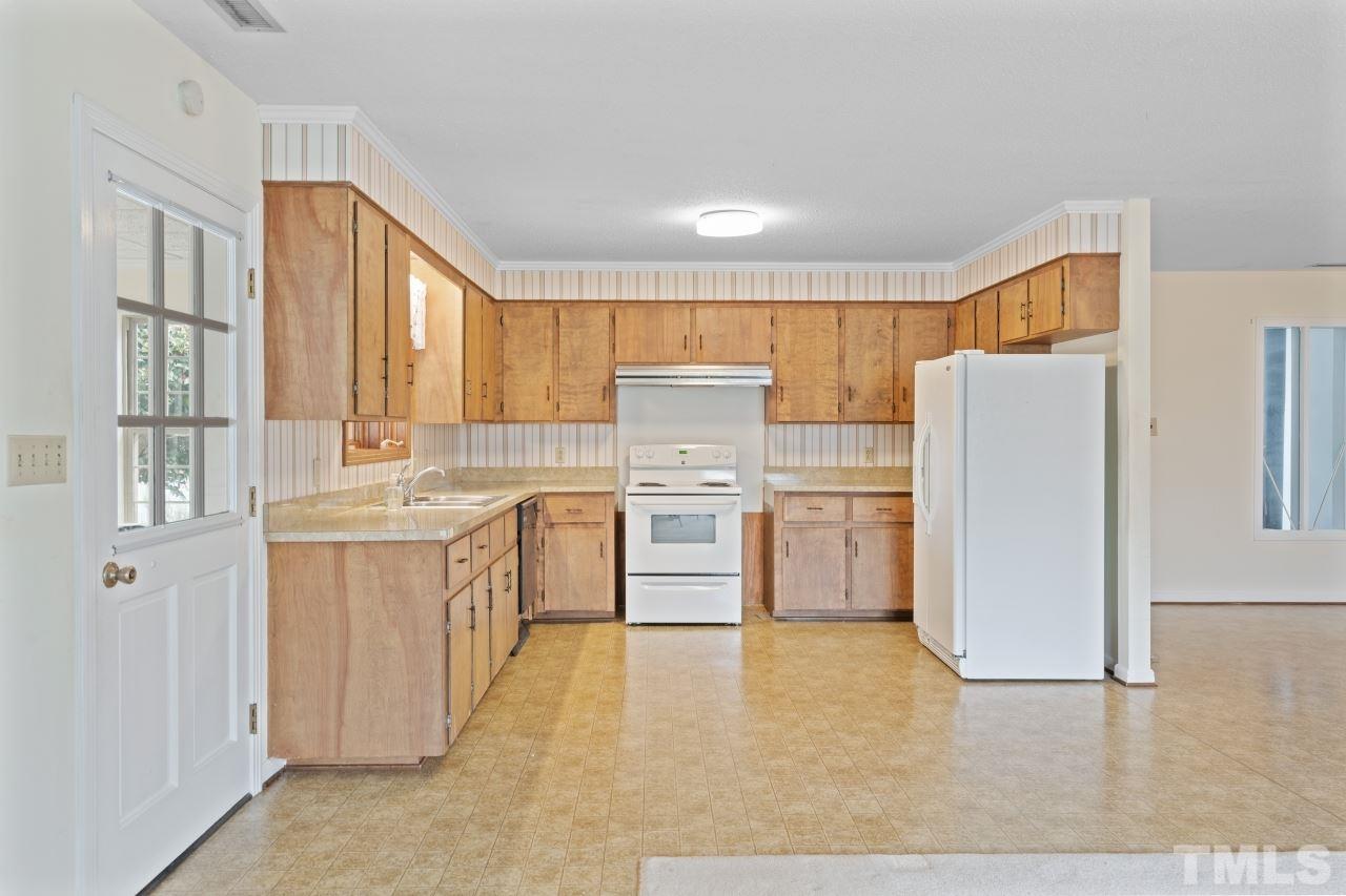 4762 Farrell Road Sanford, NC 27330 - Photo 8 of 18 a kitchen with a white stove top oven and refrigerator