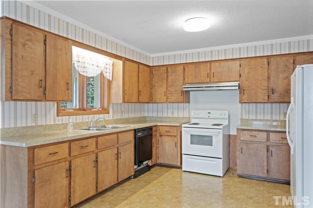 4762 Farrell Road Sanford, NC 27330 - Photo 9 of 18 a kitchen with a stove sink and cabinets