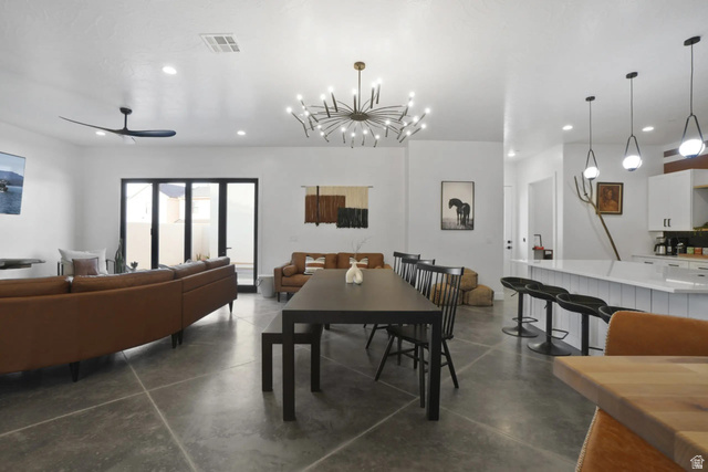 4346 Canterbury Road Hurricane, UT 84737 - Photo 8 of 37 Dining area with a ceiling fan, finished concrete floors, and a chandelier