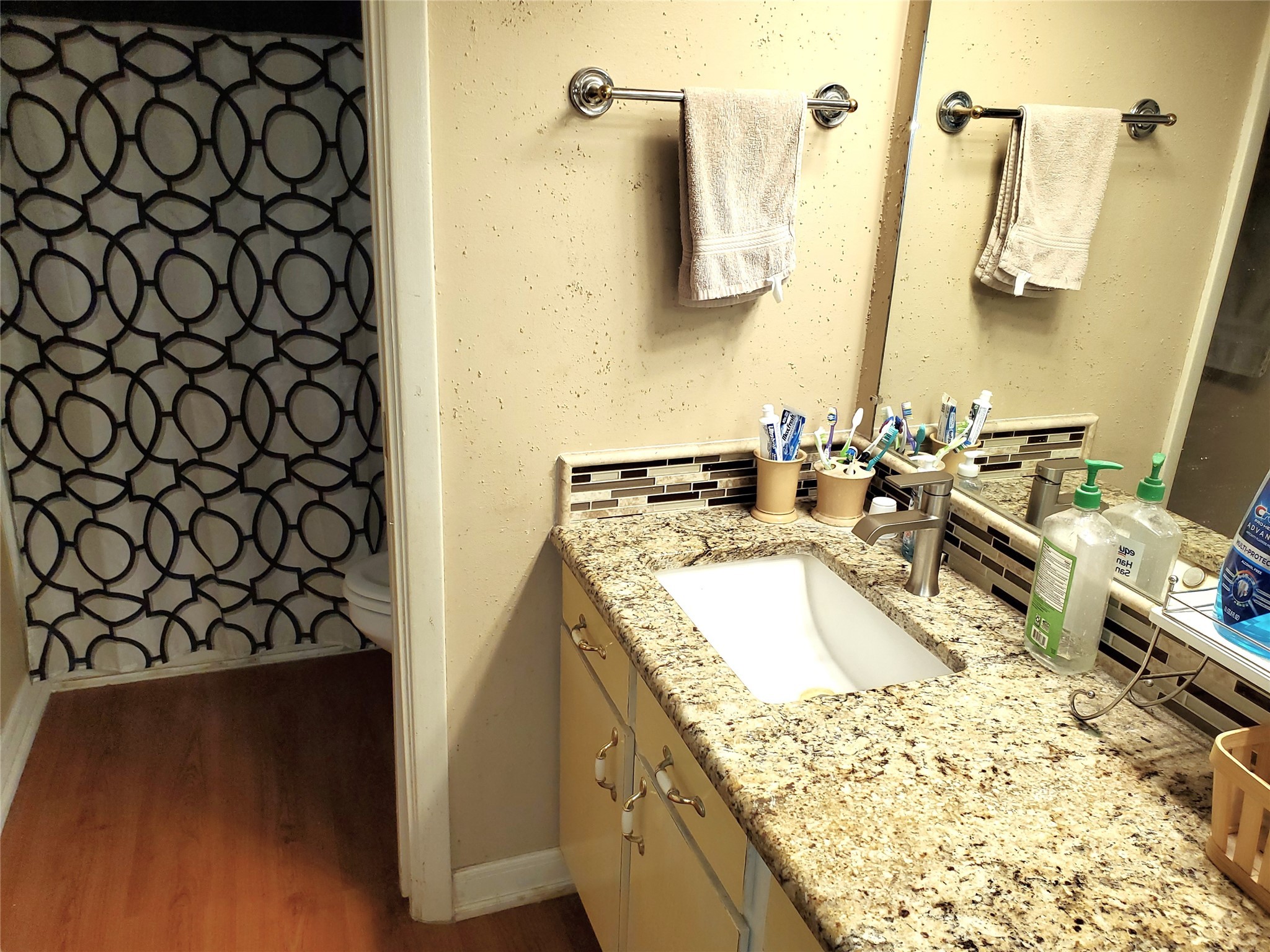 6622 Spring Haven Street San Antonio, TX 78249 - Photo 13 of 25 a bathroom with a granite countertop sink and a large mirror