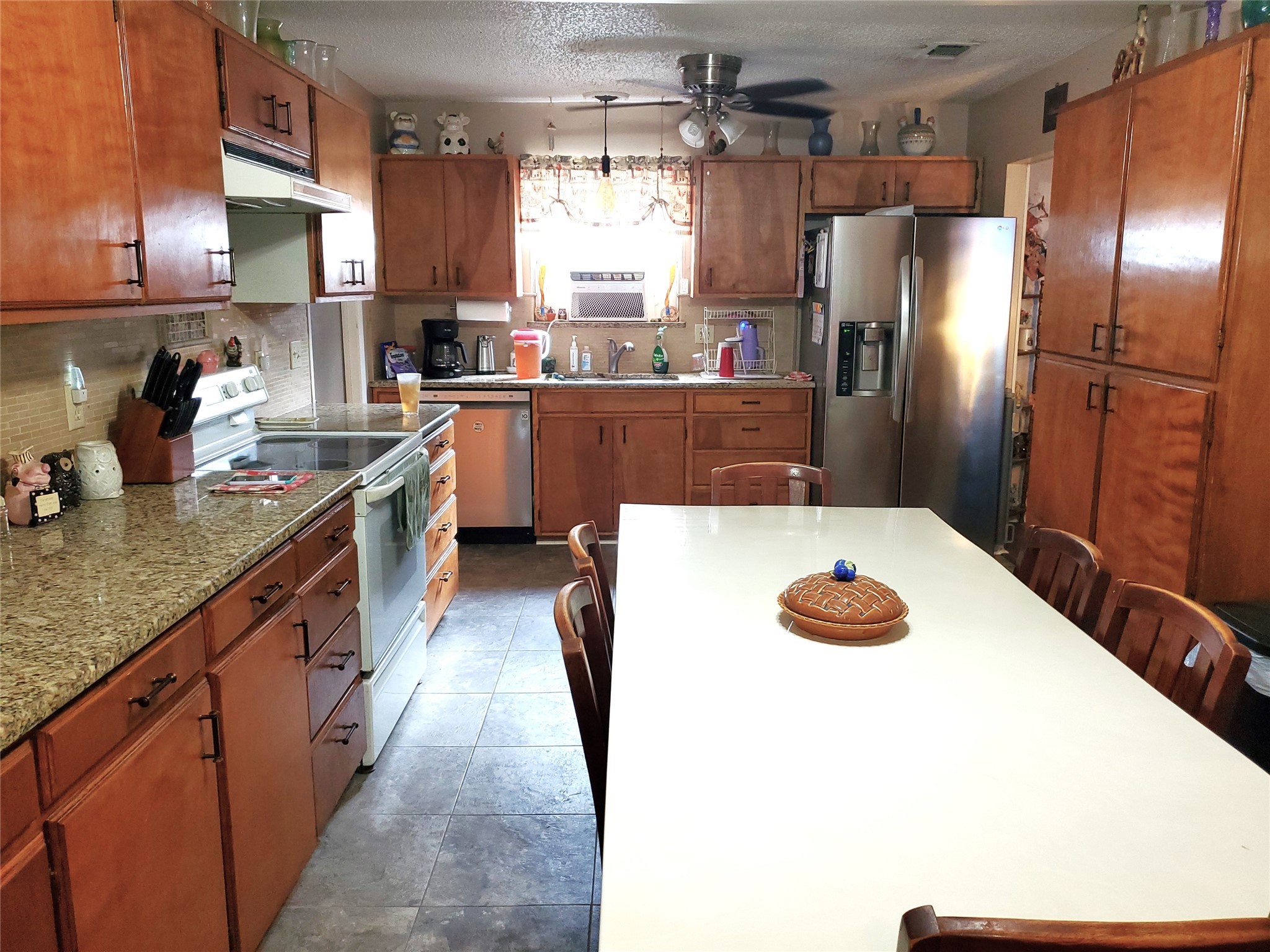 6622 Spring Haven Street San Antonio, TX 78249 - Photo 3 of 25 a kitchen with stainless steel appliances a sink and a refrigerator