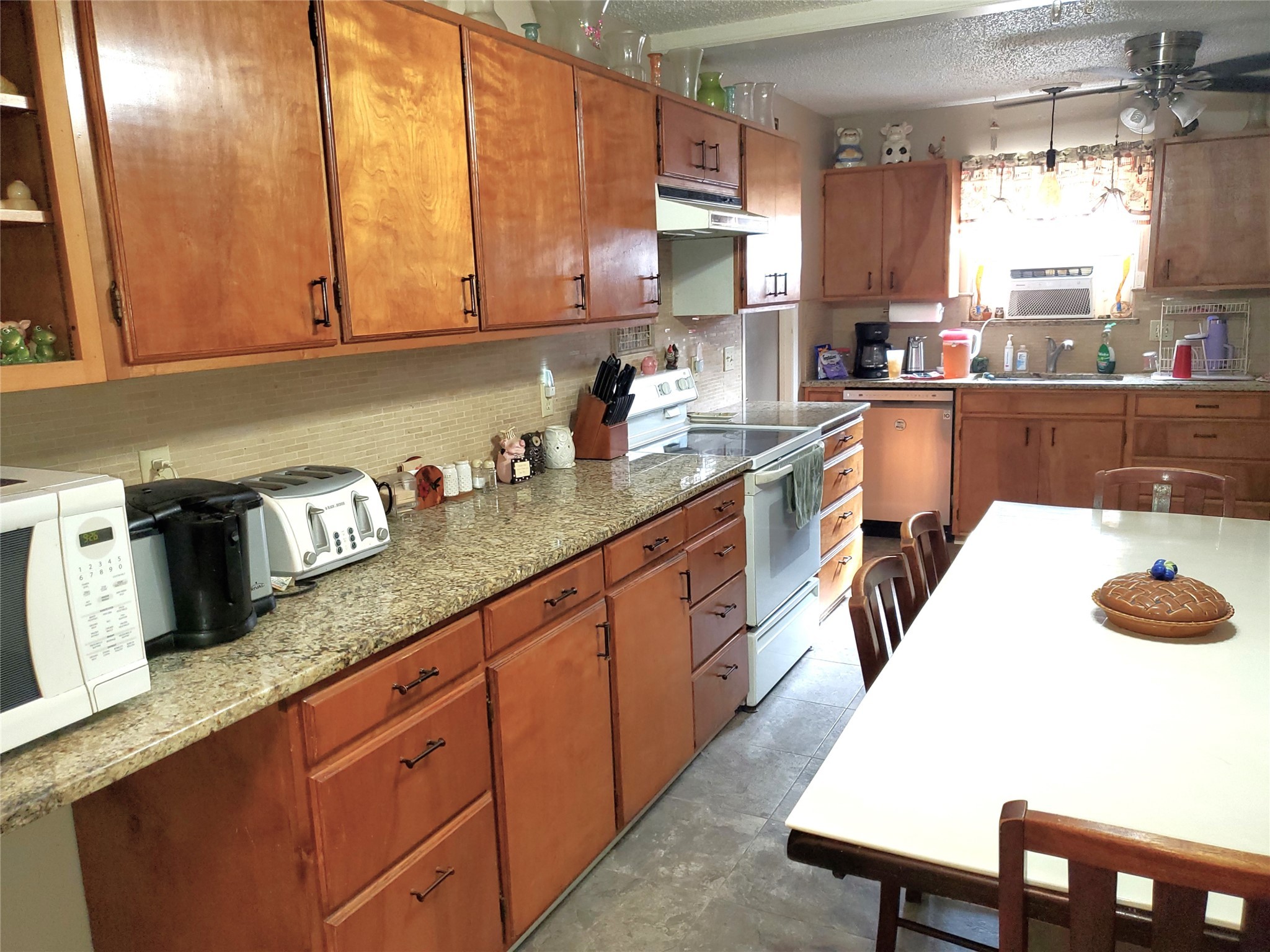 6622 Spring Haven Street San Antonio, TX 78249 - Photo 5 of 25 a kitchen with granite countertop a sink a stove and cabinets