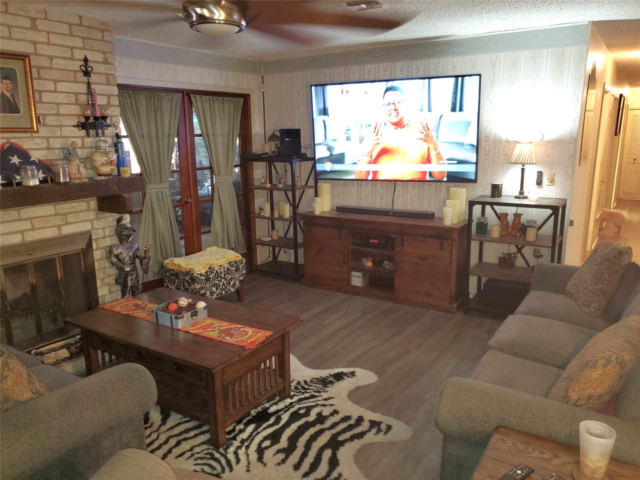 6622 Spring Haven Street San Antonio, TX 78249 - Photo 8 of 25 a living room with furniture a flat screen tv and a large window