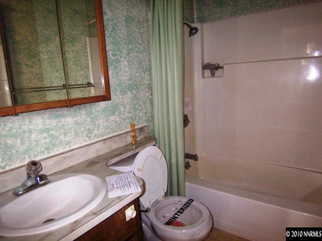 3375 Canvasback Lane Reno, NV 89508 - Photo 6 of 9 a bathroom with a sink and a mirror
