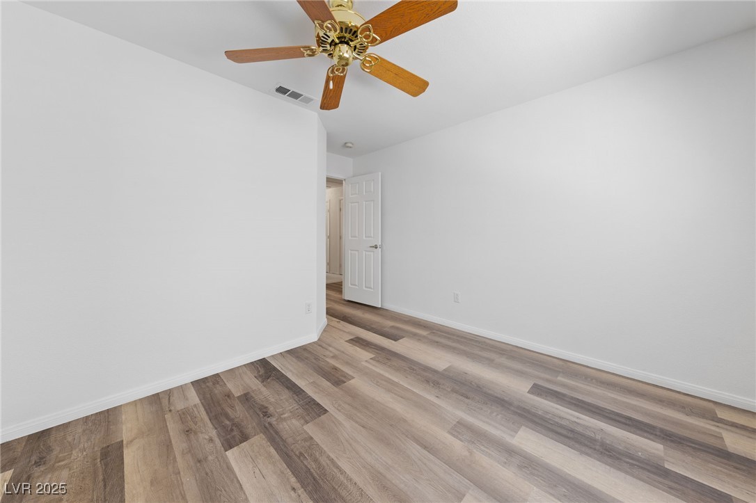 5232 Saranac Road Las Vegas, NV 89130 - Photo 19 of 34 Unfurnished room with wood finished floors, baseboards, and ceiling fan