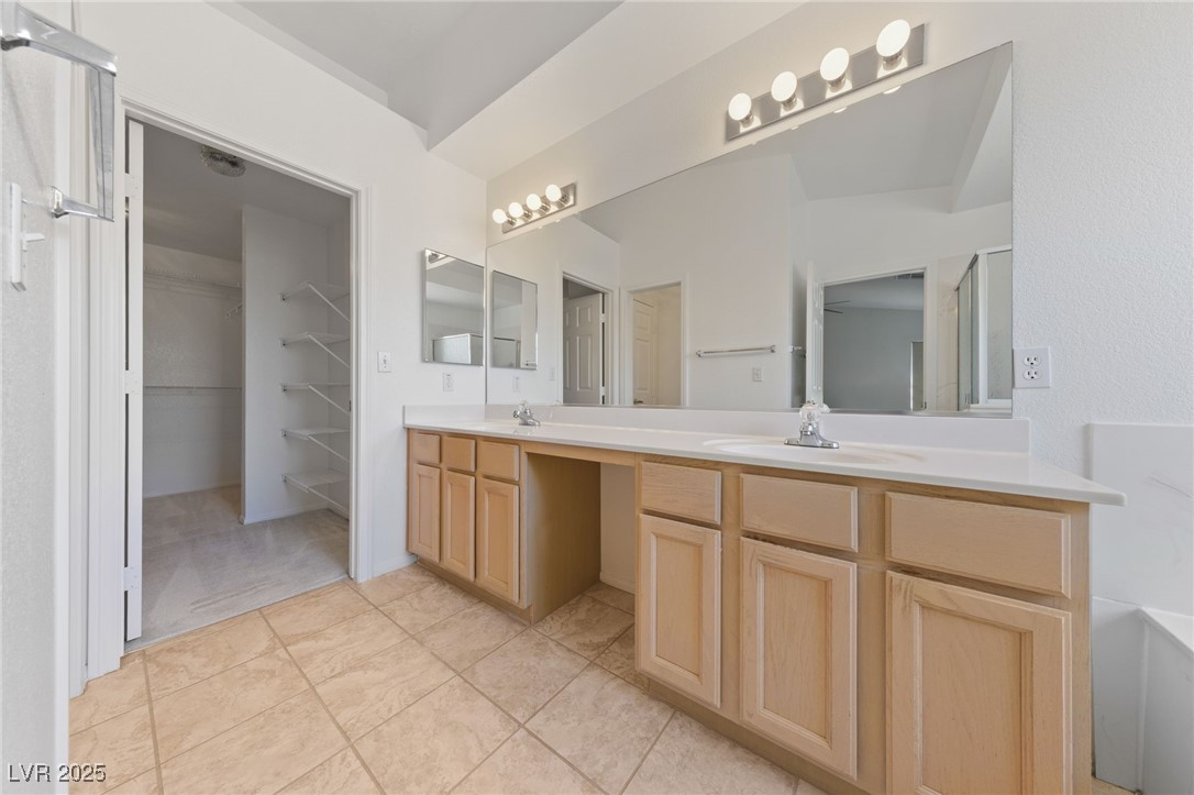 5232 Saranac Road Las Vegas, NV 89130 - Photo 21 of 34 Full bath featuring double vanity, tile patterned floors, and a walk in closet