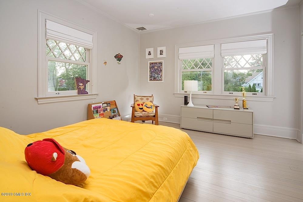 2 Keofferam Road Old Greenwich, CT 06870 - Photo 20 of 27 a spacious bedroom with a bed and a large window