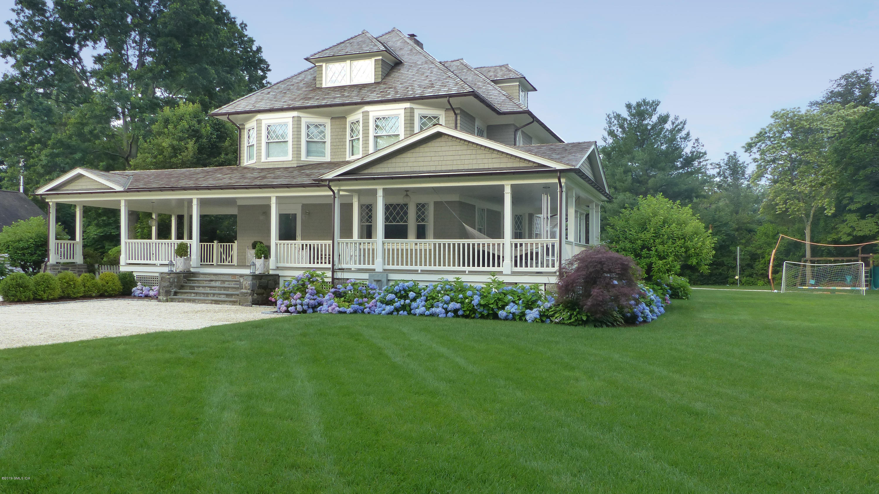 2 Keofferam Road Old Greenwich, CT 06870 - Photo 2 of 27 a front view of a house with a garden