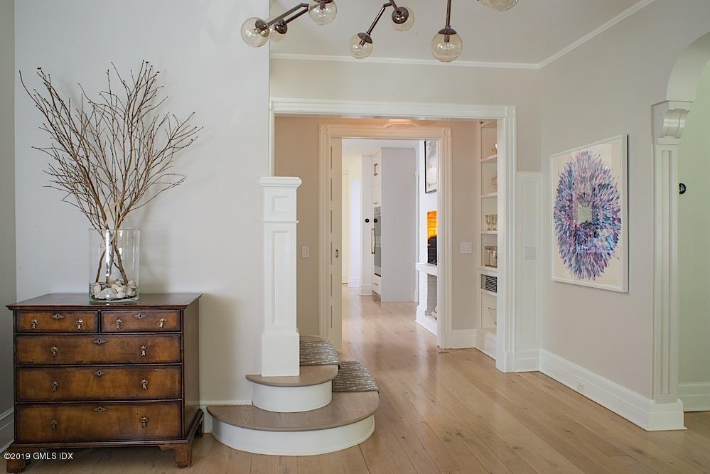2 Keofferam Road Old Greenwich, CT 06870 - Photo 6 of 27 a view of a hallway with paintings on the wall