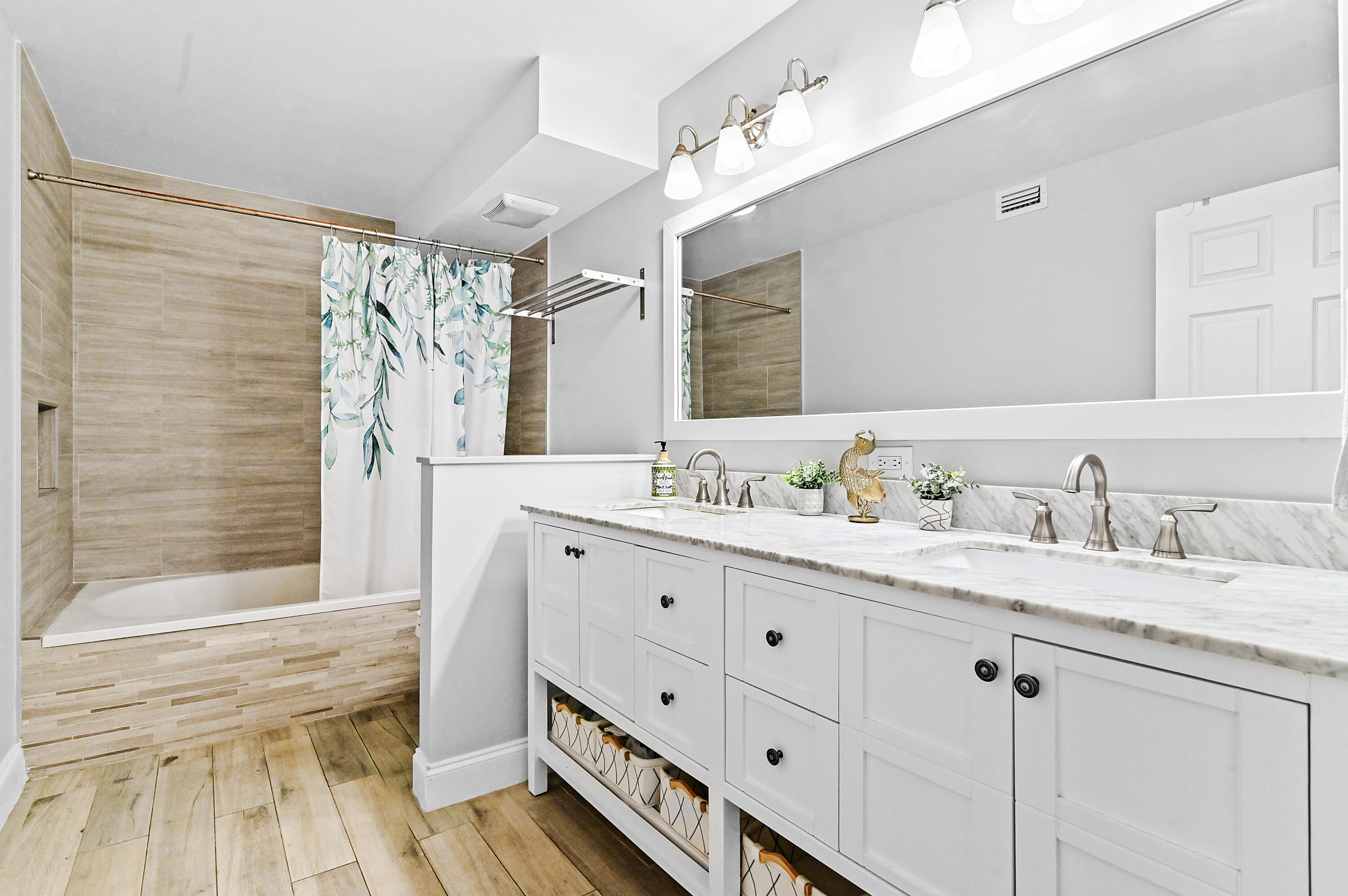 6400 Northwest 2nd Avenue, Unit 124 Boca Raton, FL 33487 - Photo 21 of 33 a bathroom with double vanity sink a mirror and a shower