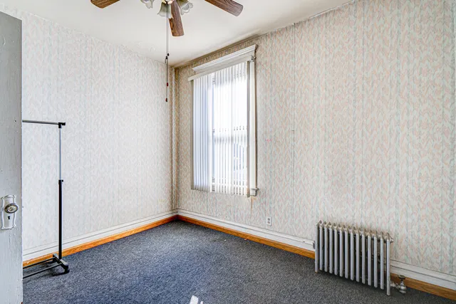 a hallway with stairs and wooden floor