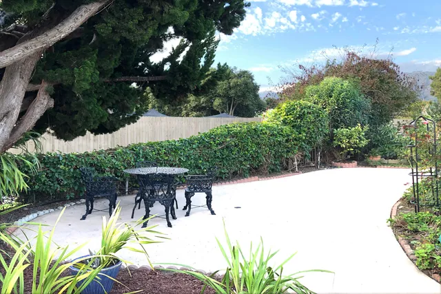 a view of backyard with swimming pool and outdoor seating