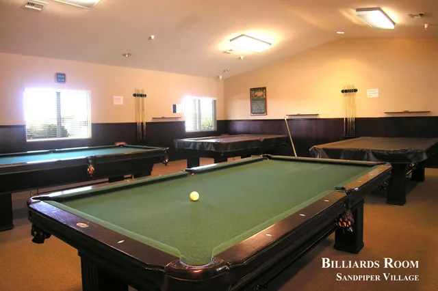 a view of a patio with a table chairs and a floor to ceiling window