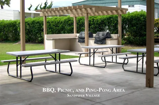 a large dining space with furniture a chandelier and a flat screen tv