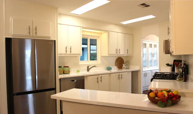 a kitchen with a refrigerator and a sink