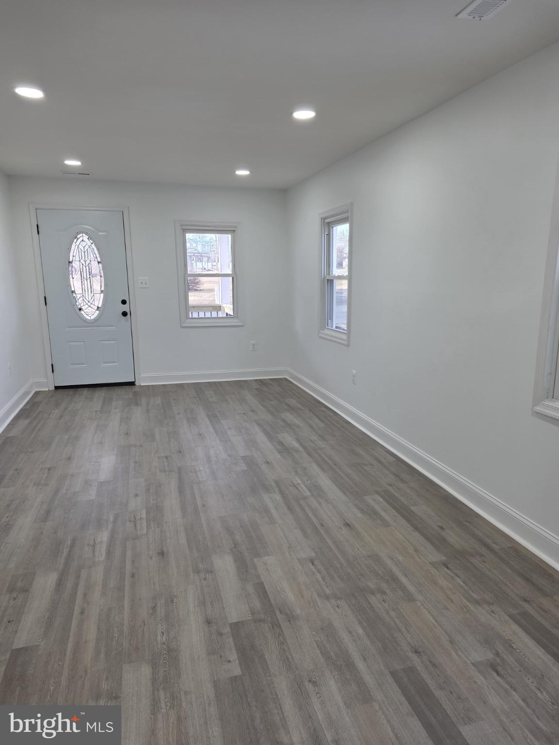 580 York Avenue Winchester, VA 22601 - Photo 2 of 12 an empty room with wooden floor and windows