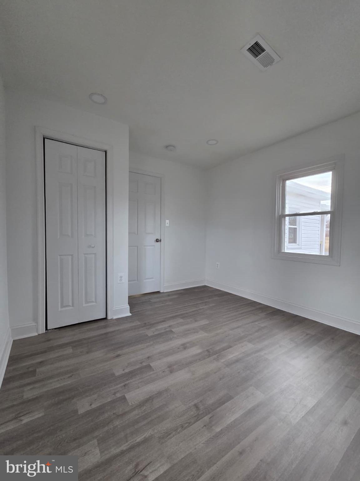 580 York Avenue Winchester, VA 22601 - Photo 6 of 12 a view of an empty room with wooden floor and a window