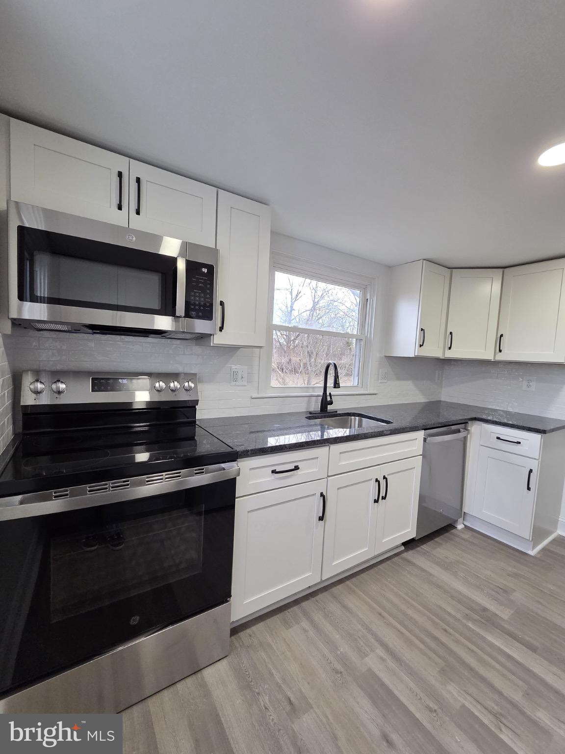 580 York Avenue Winchester, VA 22601 - Photo 9 of 12 a kitchen with stainless steel appliances kitchen island granite countertop a stove and a sink