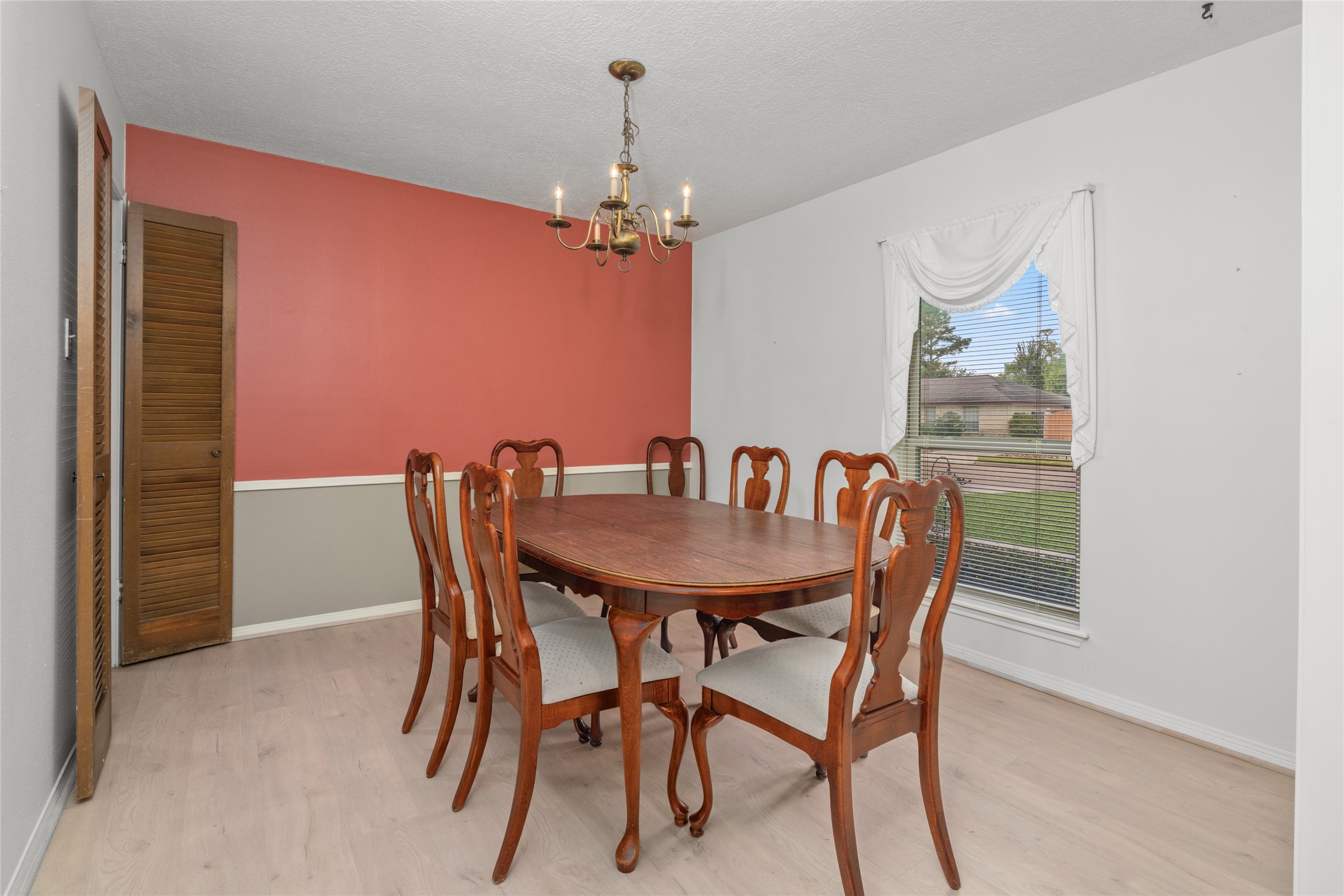 7015 Rosebrook Circle Spring, TX 77379 - Photo 5 of 15 Elegant formal dining room highlights include durable luxury vinyl plank flooring and an updated window with a view.