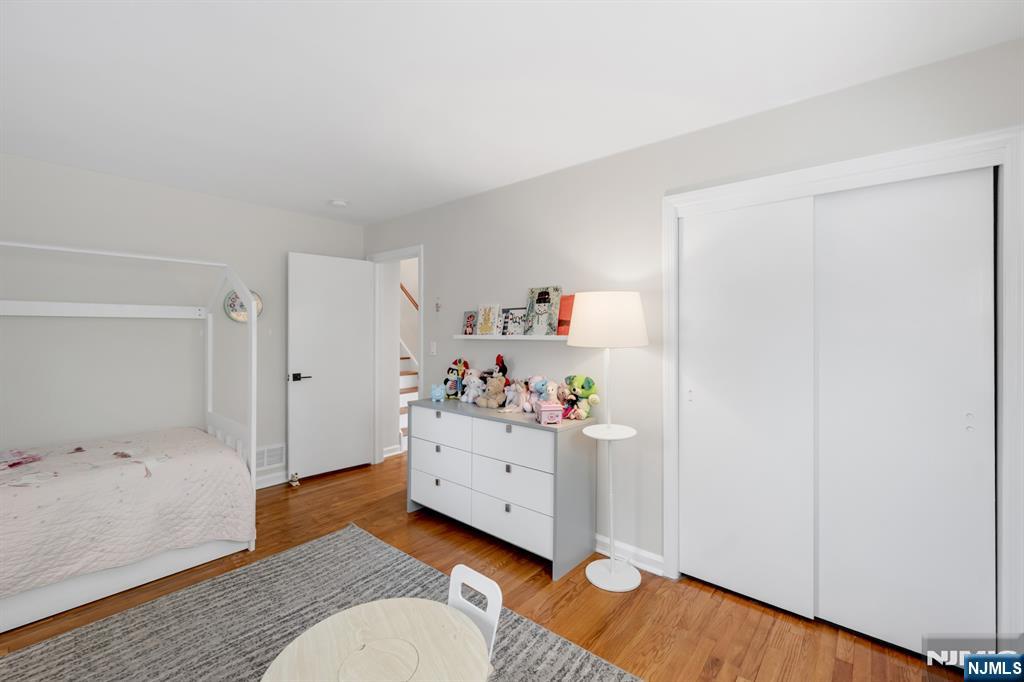 433 Piermont Road Cresskill, NJ 07626 - Photo 25 of 49 a bedroom with a bed and wooden floor
