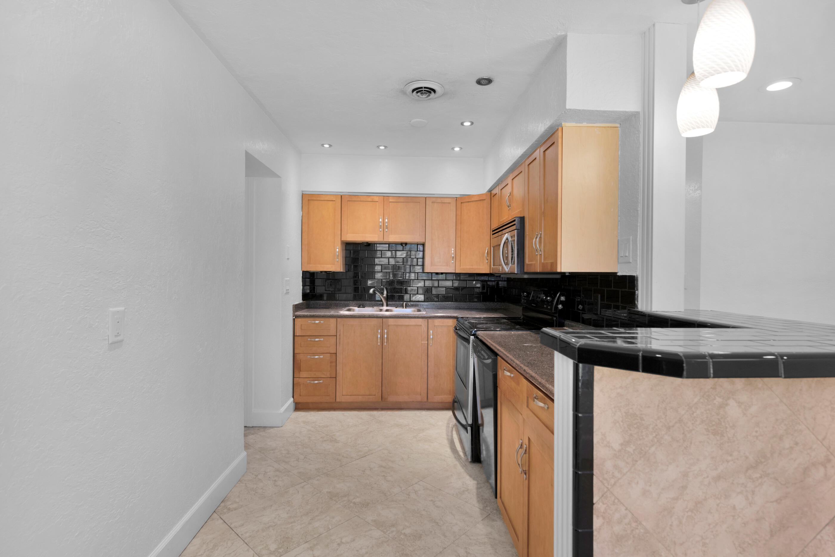600 Shrewsbury Road Mary Esther, FL 32569 - Photo 13 of 25 a kitchen with stainless steel appliances granite countertop a stove a sink and a microwave