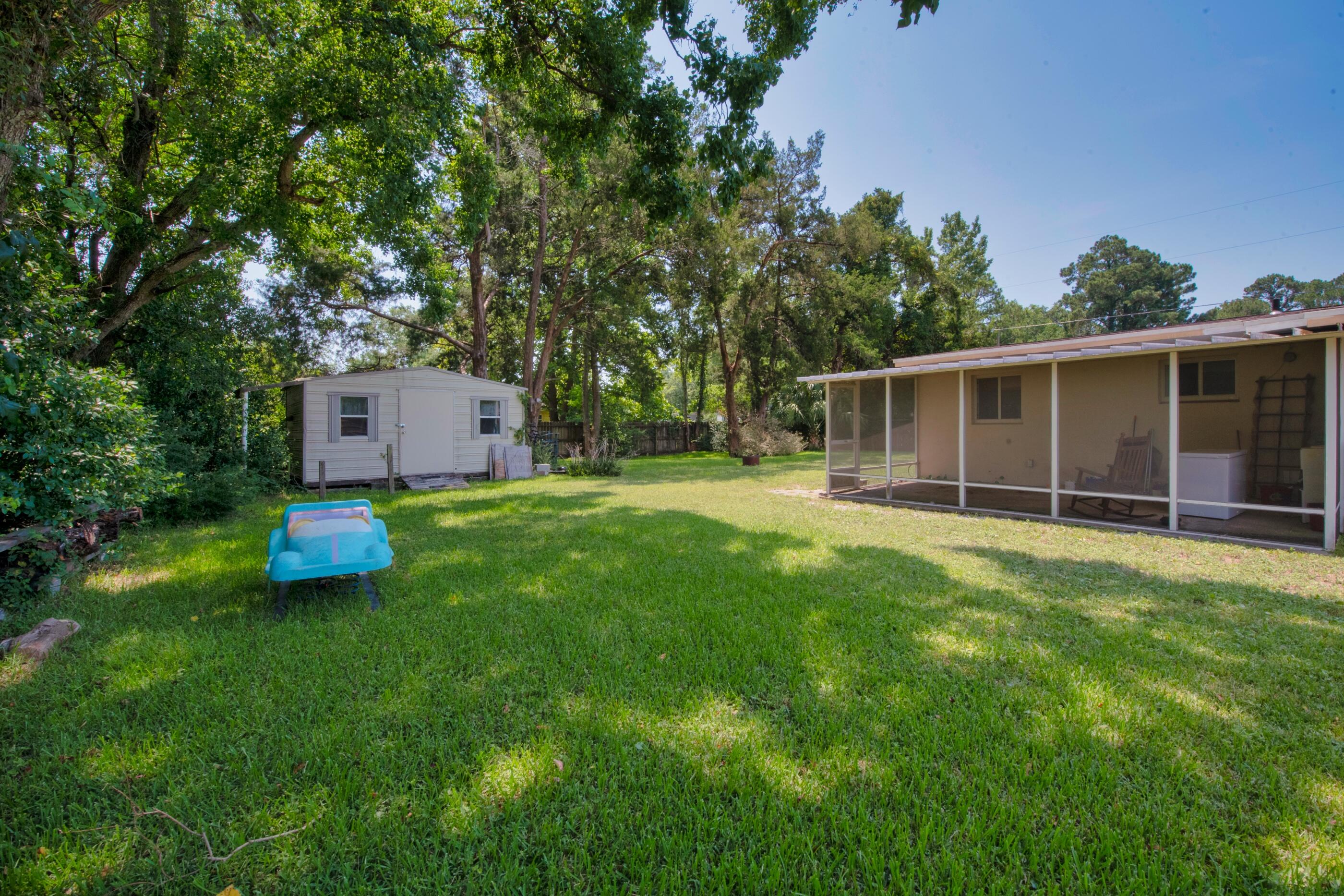 600 Shrewsbury Road Mary Esther, FL 32569 - Photo 22 of 25 a view of a house with backyard sitting area and garden